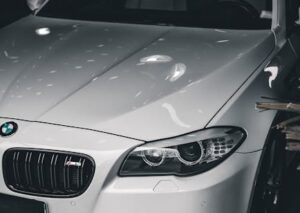 Luxury Cars - Stylish white luxury car with BMW badge under so #11291684