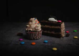 Food Aesthetics - Close-up of a chocolate cake slice and cupcake w #11774178