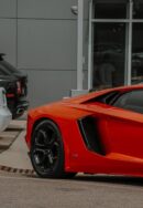 Luxury Cars - Close-up of a red sports car parked in an urban #12565903