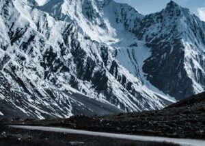 Mountain Landscapes - Stunning view of snow-covered peaks against a dr #12566351