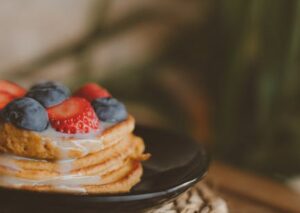 Food Aesthetics - Stack of pancakes topped with fresh strawberries #14716736