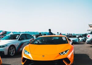Luxury Cars - An orange Lamborghini stands out at an outdoor c #14843593