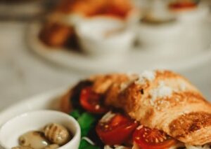 Food Aesthetics - Close-up of a croissant sandwich filled with fre #17598061