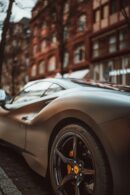 Luxury Cars - A stylish gray supercar parked in a vibrant city #20297007