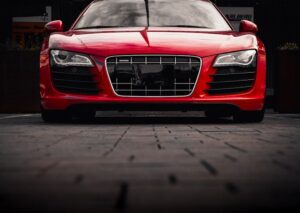 Luxury Cars - Front view of a sleek red sports car parked outd #28554694