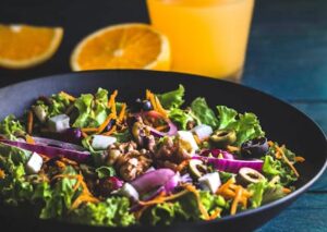 Food Aesthetics - Bowl with tasty salad with green leaves and slic #6896283